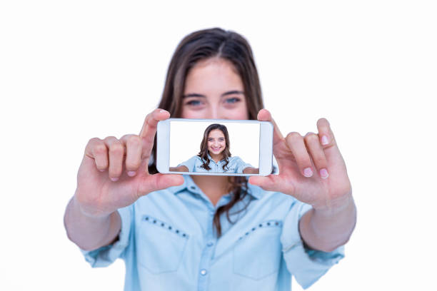 istock Pretty brunette taking a selfie with smartphone 692999722
