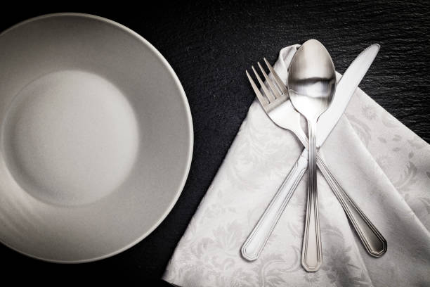 istock Place setting shot directly above on dark background 692999844