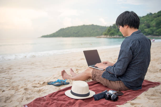 istock Young Asian businessman working with laptop computer in cafe 693003278