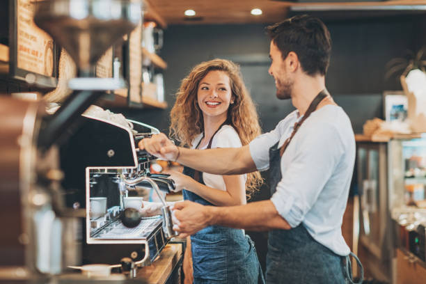 istock Beautiful cheerful baristas working together 693007364