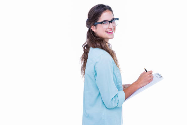 istock Pretty geeky hipster writing on notebook and smiling at camera 693010930