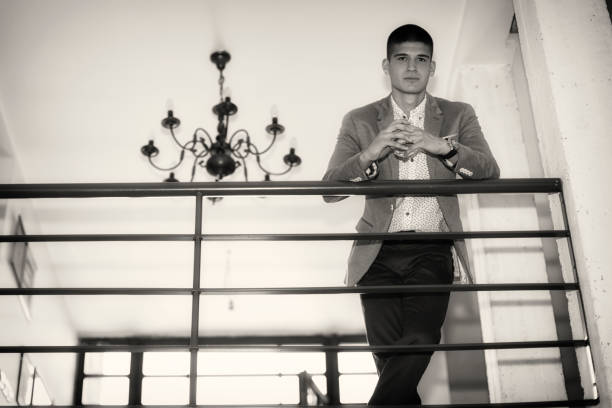 istock Young businessman smoke a cigar and hold whiskey 693013382