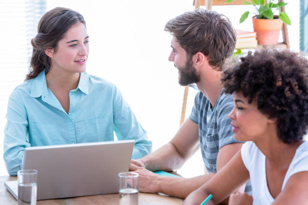 istock Creative business people using laptop in meeting 693017164