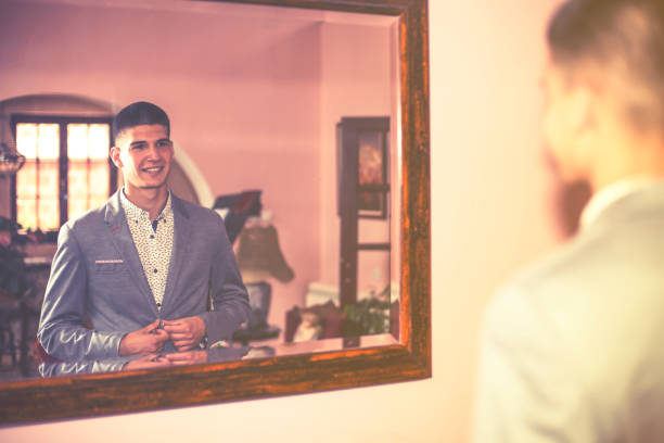 istock Good looking businessman looking in a mirror 693017312