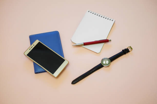 istock Business desk with wallet, notebook, a smart phone, watch, pen. Working desk table concept. 693020710