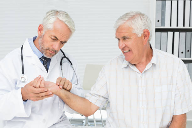 istock Male doctor taking a senior patients pulse 693023206