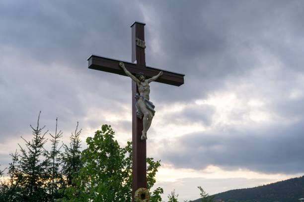 istock Cross with Christ during sunset. 693026594