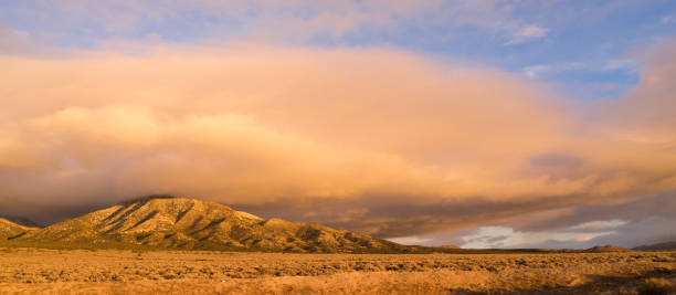 istock Panoramic Landscape Clouds Over Hillside Sunset Orange Glow 693026906