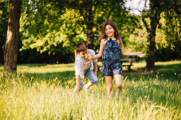 istock Brother and sister running in flower field 693030270