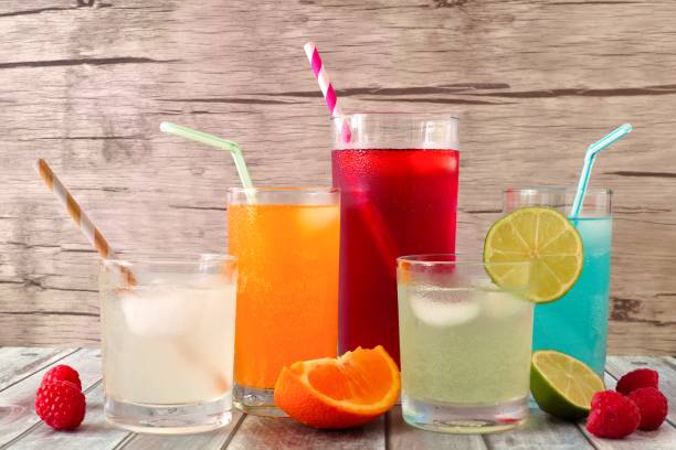 istock Cold colorful summer drinks against wood 693030714