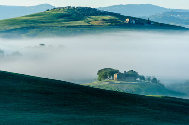 istock Morning fog settles around farm 693030950