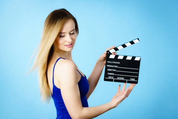 istock Woman holding professional film slate 693036604