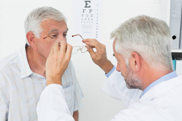 istock Man wearing glasses after taking vision test at doctor 693036824