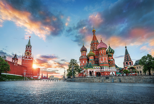 St. Basil's Cathedral and the Spasskaya Tower of the Moscow Kremlin and the summer sunset with colorful clouds