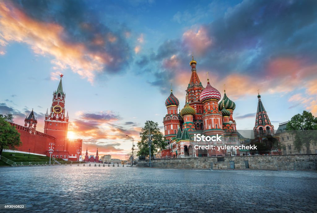 St. Basil's Cathedral and the Spasskaya Tower St. Basil's Cathedral and the Spasskaya Tower of the Moscow Kremlin and the summer sunset with colorful clouds Moscow - Russia Stock Photo