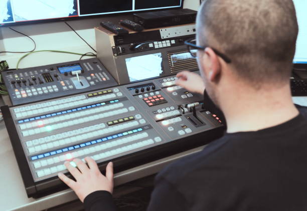 istock TV editor working with audio video mixer in a television broadcast 693041092