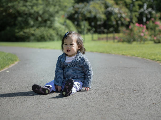 istock baby girl playing on spring garden 693041786