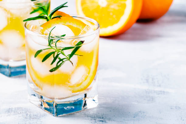 istock Refreshing drink with orange, rosemary and ice, selective focus 693047512