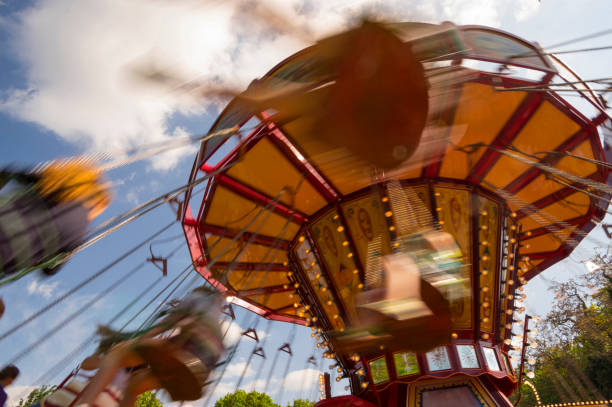 istock Swinging ride at a carnival with motion blur 693049944