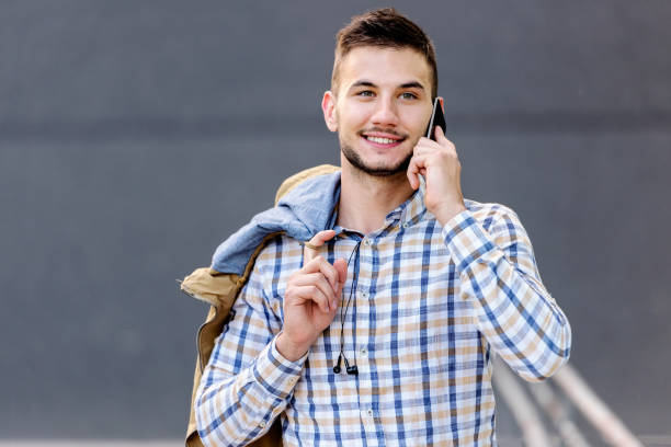 istock Young business man talking on cell phone outdoors 693049978