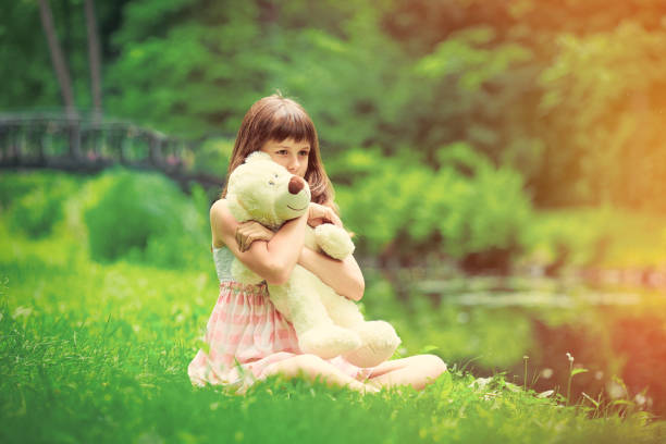istock Little girl playing with teddy bear 693051448