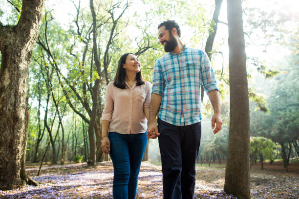istock Happy couple walking outdoors and smiling 693061258