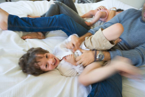 istock Family playing on the bed. 693063430