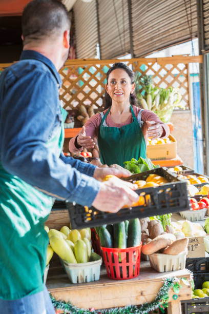 istock Couple working in fruit and vegetable stand 693063668