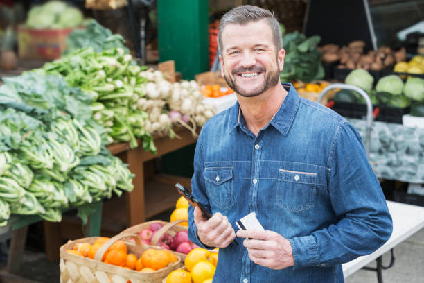 istock Worker at produce market processing credit card 693063958