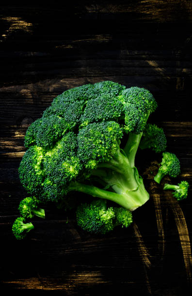 istock Fresh broccoli on a dark wooden background 693064154