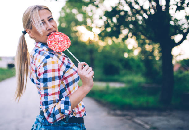 istock Young woman with lollipop 693064276