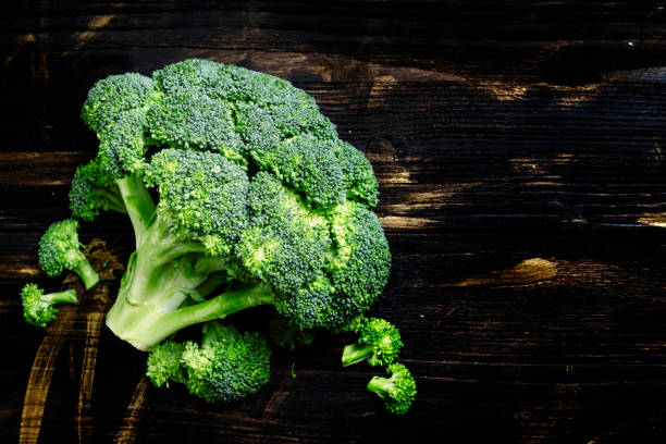 istock Fresh broccoli on a dark wooden background 693064372