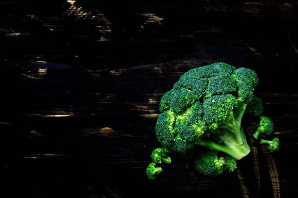 istock Fresh broccoli on a dark wooden background 693066478