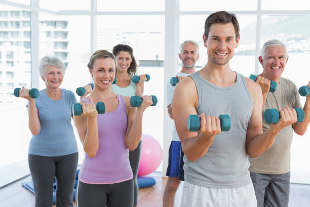 istock Class exercising with dumbbells in gym 693067400