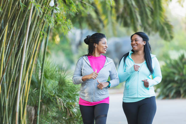 istock Two African American women jogging together 693070140