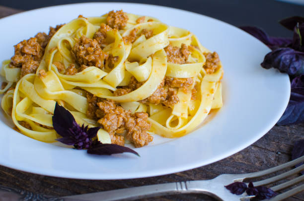 istock Pasta with bolognese sauce on wooden background 693070276