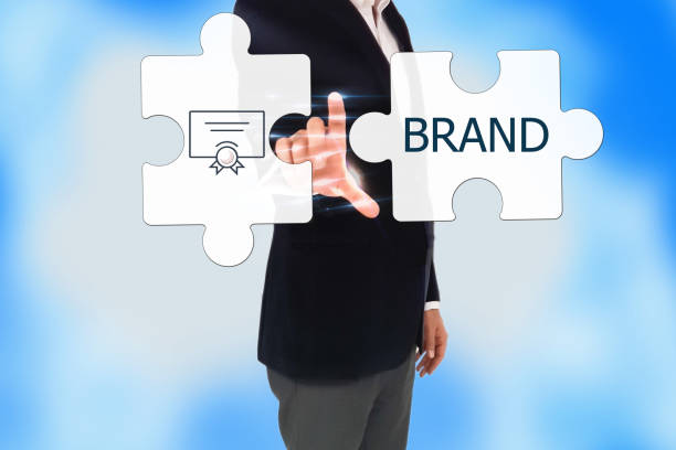 istock business man hand pressing a touch screen button, BRAND Collaboration Jigsaw Puzzle Concept. Businessman pressing 'BRAND' button on virtual touch screen on blue technology background 693070938
