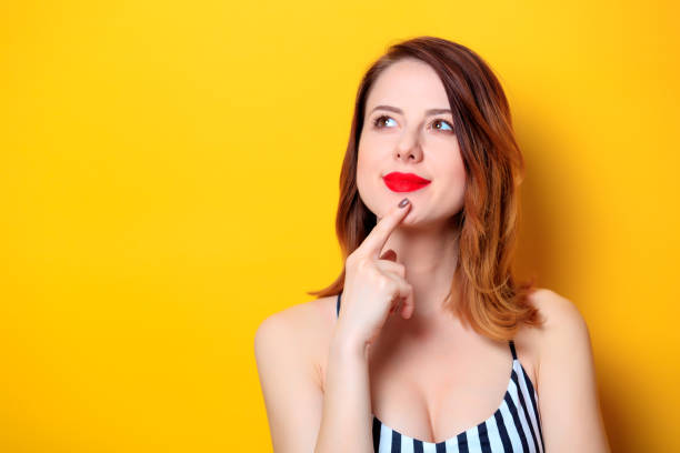 istock Beautiful woman on yellow background 693071636