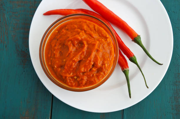istock Flat lay view of a hot chilli sauce served with fresh chillies 693075262