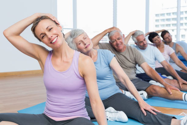 istock Class stretching neck in row at yoga class 693088482