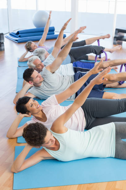 istock Fitness class stretching legs and hands in row 693091324