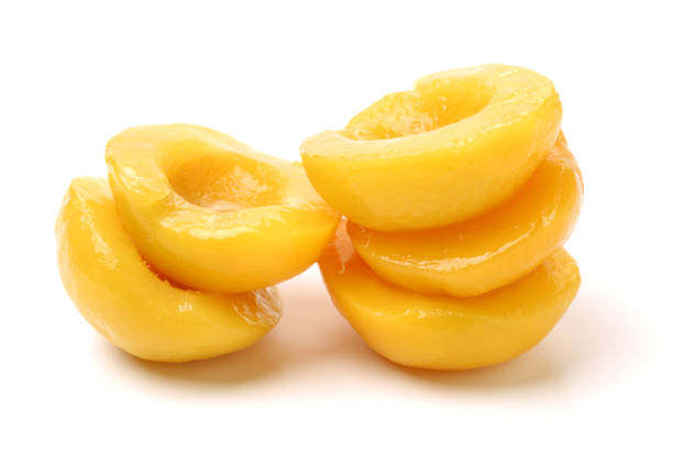 istock Canned peach on syrup over white background 693102874