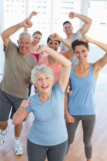 portrait of smiling people doing power fitness exercise - senior adult sport yoga exercising imagens e fotografias de stock