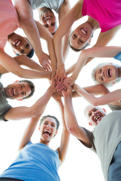 istock Happy sporty people holding hands together 693106240