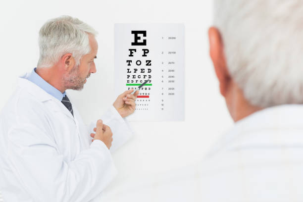 istock Pediatrician ophthalmologist with senior patient pointing at eye chart 693106344