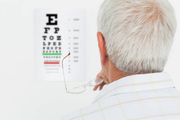 istock Rear view of a senior man looking at eye chart 693106392