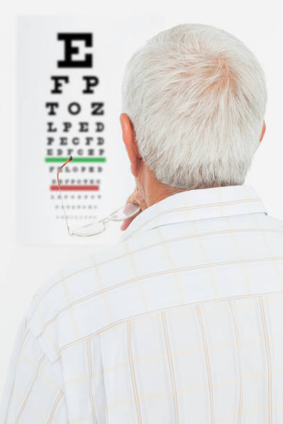 Rear view of a senior man looking at eye chart