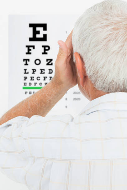 istock Rear view of a senior man looking at eye chart 693106426