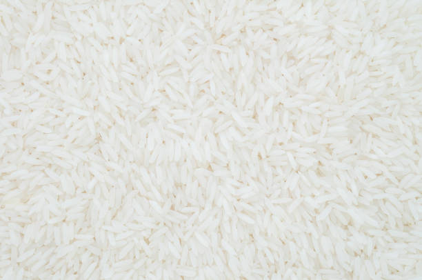istock Closeup pile of white rice called jasmine rice textured background 693112198