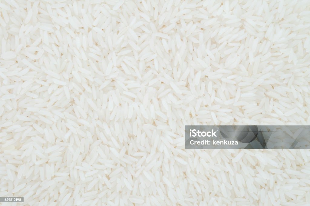Closeup pile of white rice called jasmine rice textured background Agriculture Stock Photo